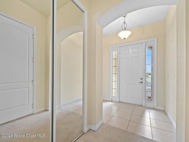 foyer entrance featuring light carpet