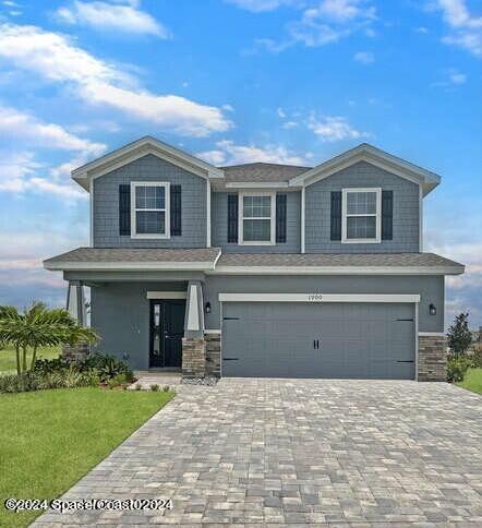 view of front of house featuring a garage and a front lawn