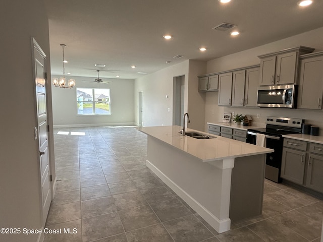 kitchen featuring a sink, appliances with stainless steel finishes, and gray cabinets