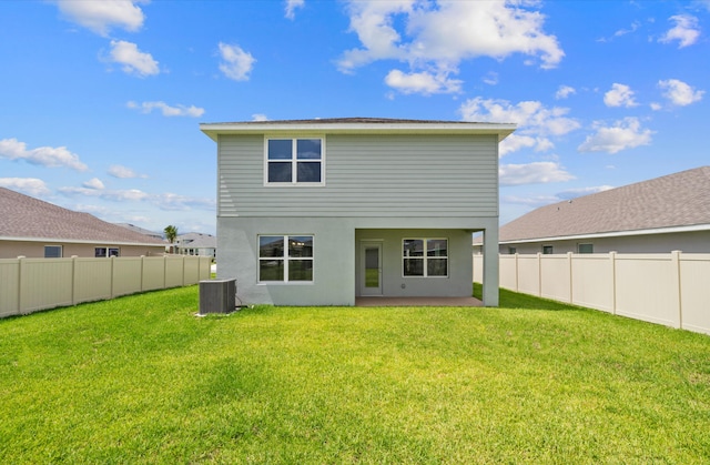 rear view of house featuring a fenced backyard, central AC unit, and a yard