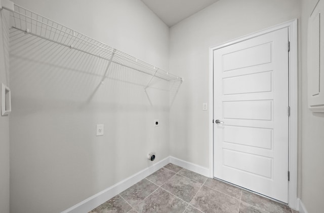 laundry area with hookup for an electric dryer and light tile patterned floors