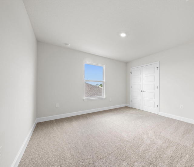 unfurnished bedroom with carpet flooring and a closet