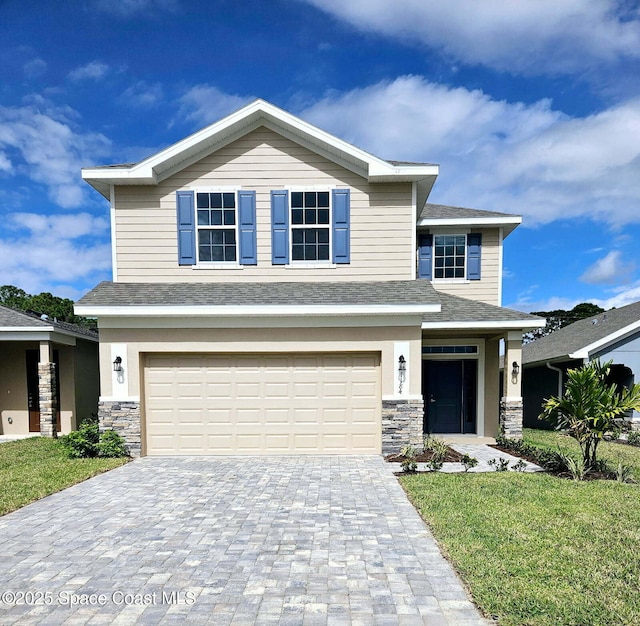 view of front facade featuring a front lawn and a garage