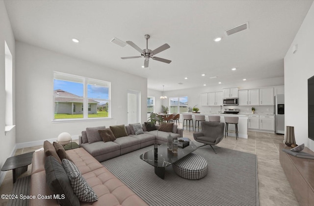 living room with ceiling fan and light tile patterned floors