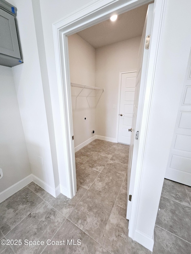 laundry area featuring hookup for an electric dryer and cabinets