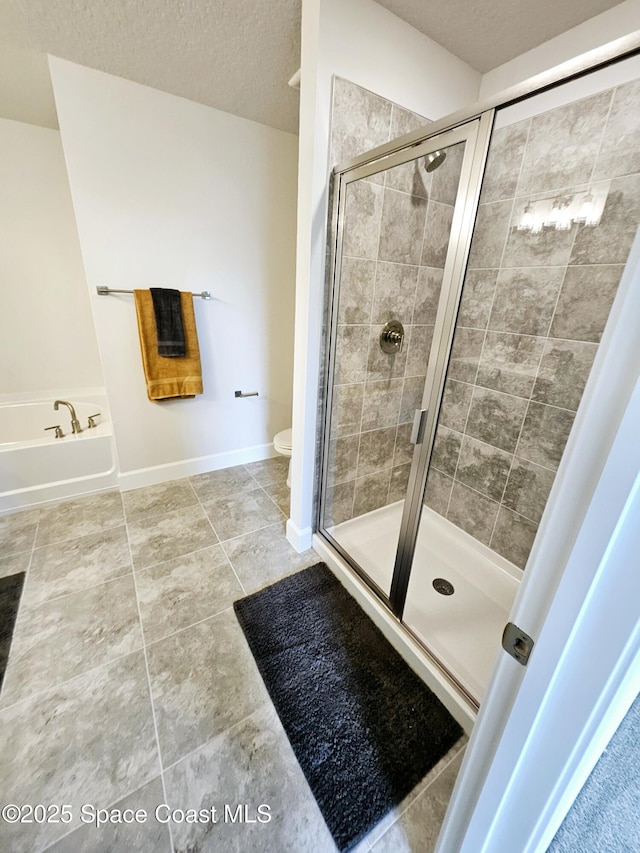 bathroom with toilet, independent shower and bath, tile patterned flooring, and a textured ceiling