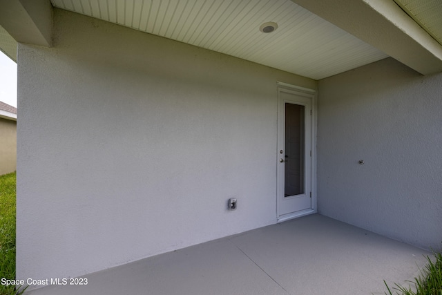 entrance to property featuring a patio