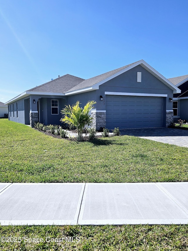 ranch-style house with a garage and a front lawn