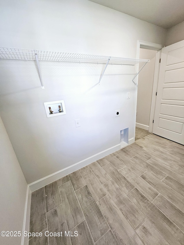 laundry room with electric dryer hookup, washer hookup, and light hardwood / wood-style flooring