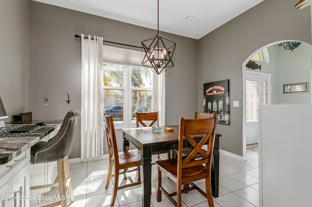 tiled dining area featuring an inviting chandelier