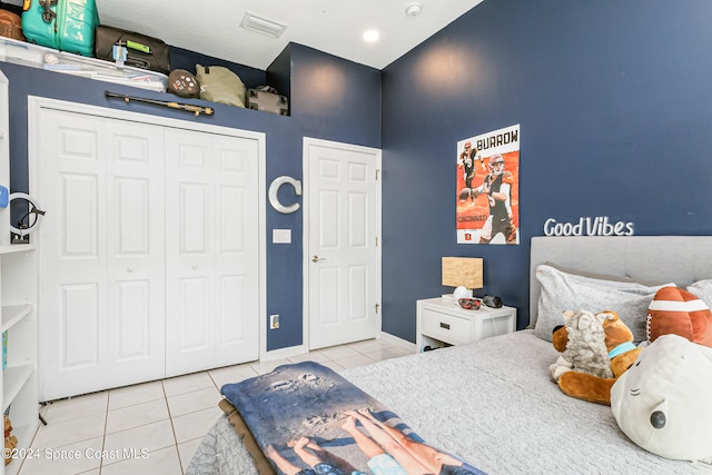 tiled bedroom featuring a closet