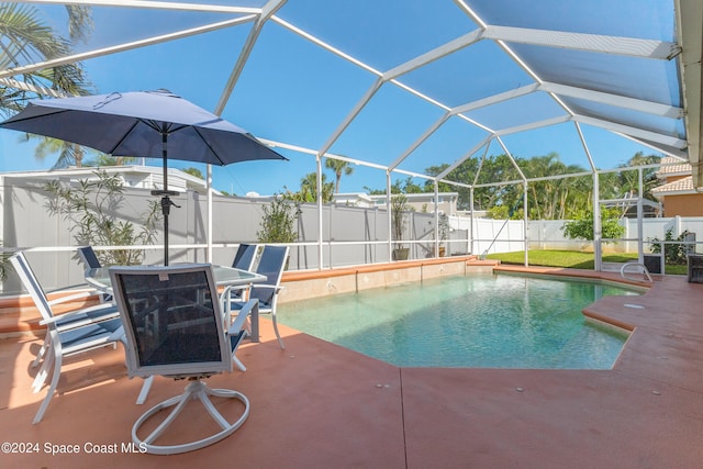 view of swimming pool with a patio area and glass enclosure