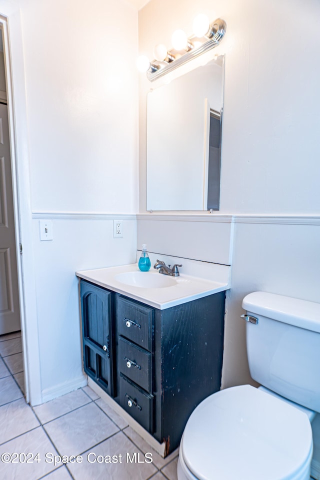 bathroom featuring tile patterned flooring, vanity, and toilet