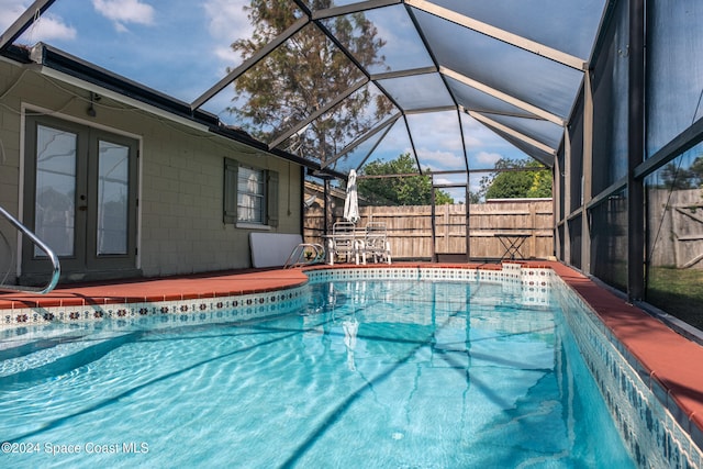 view of pool featuring glass enclosure