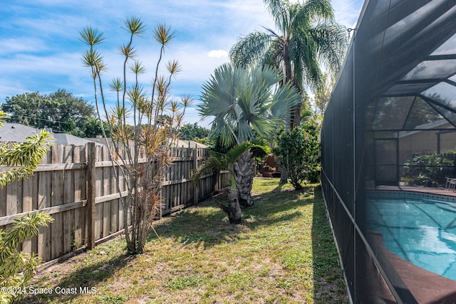 view of yard with glass enclosure