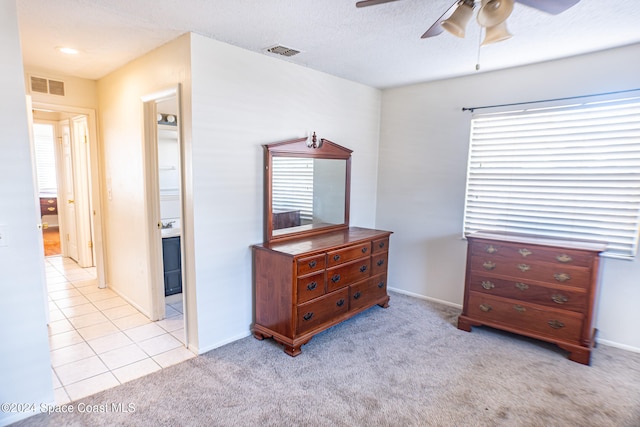 carpeted bedroom with connected bathroom and ceiling fan