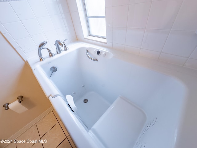 bathroom with tile patterned floors and a bathtub