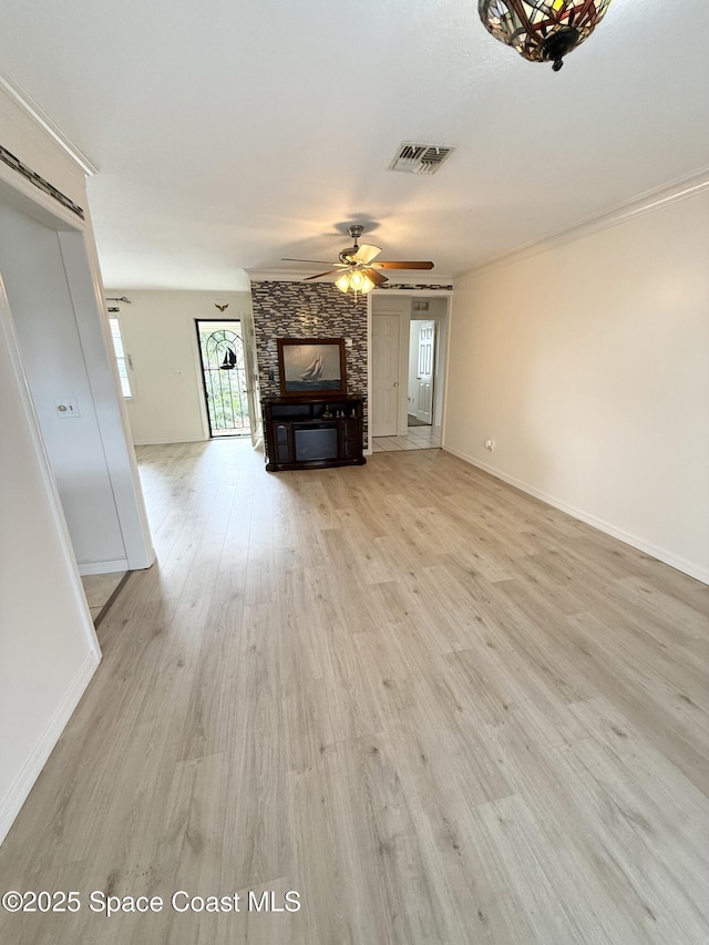 unfurnished living room featuring ceiling fan, ornamental molding, and light hardwood / wood-style floors