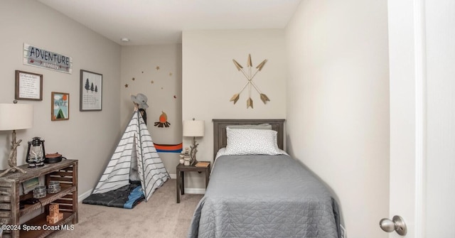 bedroom featuring light carpet