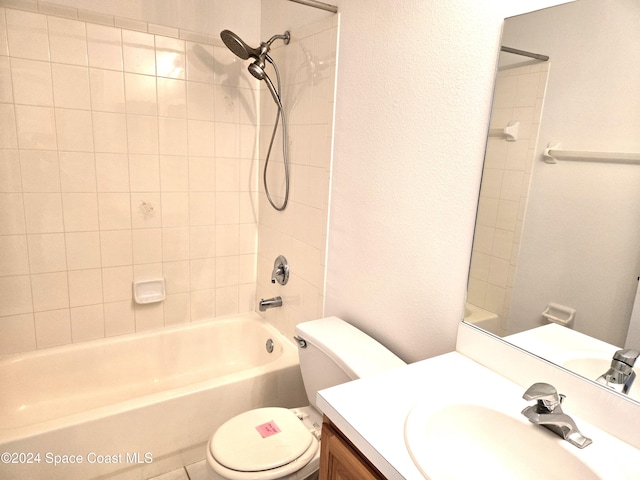 full bathroom featuring toilet, tiled shower / bath combo, and vanity