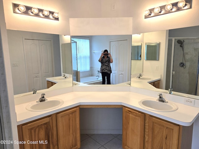 bathroom with vanity, plus walk in shower, and tile patterned flooring