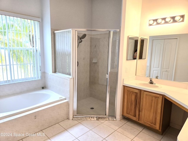 bathroom featuring a wealth of natural light, vanity, separate shower and tub, and tile patterned flooring