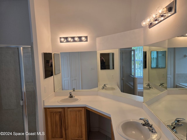 bathroom featuring vanity and an enclosed shower