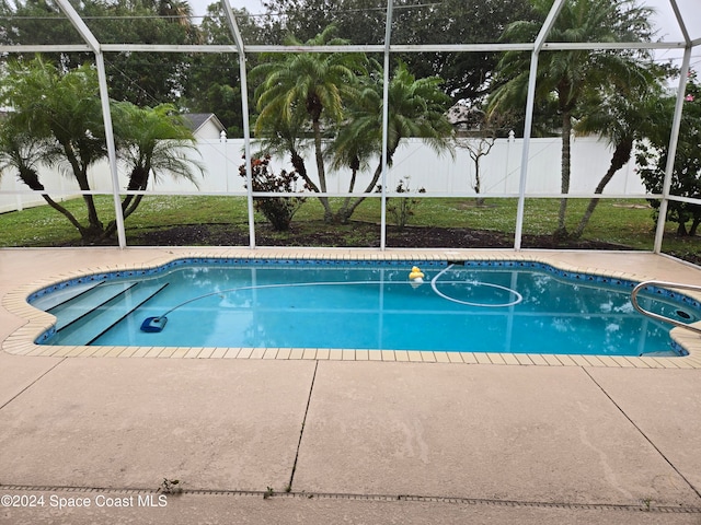 view of pool with a patio and a lanai