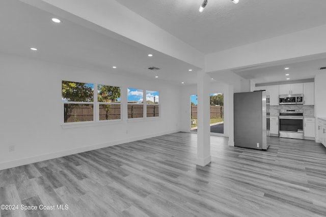 unfurnished living room featuring light wood-type flooring