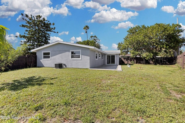 rear view of house featuring central AC, a yard, and a patio