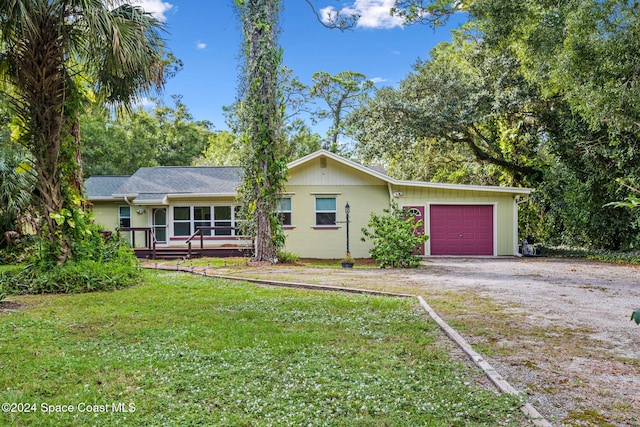 ranch-style home with a front yard and a garage