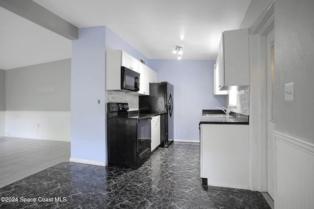 kitchen featuring white cabinetry, black appliances, sink, and tasteful backsplash