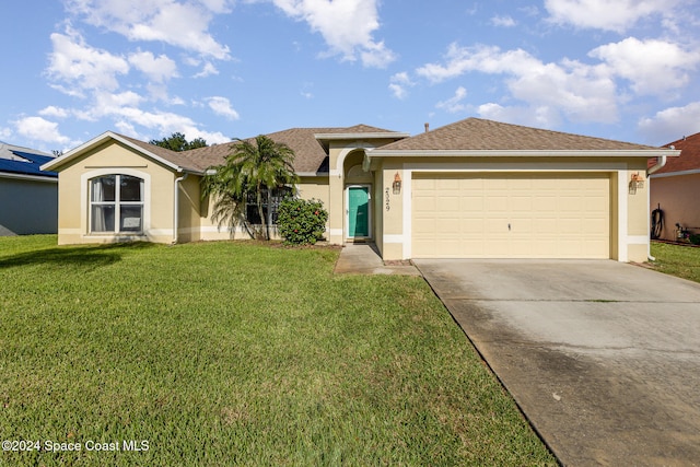 ranch-style house featuring a front lawn and a garage