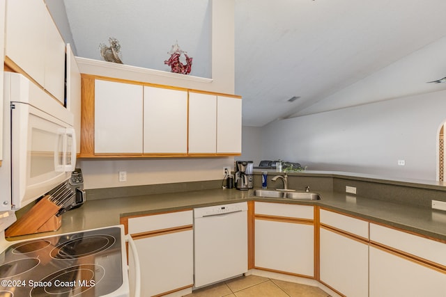 kitchen with white appliances, light tile patterned flooring, sink, white cabinetry, and vaulted ceiling