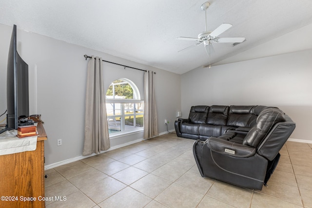 living room featuring a textured ceiling, ceiling fan, light tile patterned floors, and vaulted ceiling