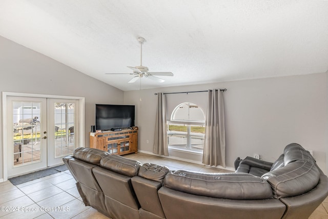 tiled living room featuring french doors, ceiling fan, a healthy amount of sunlight, and vaulted ceiling