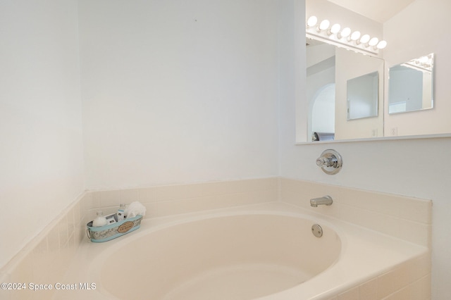 bathroom with a relaxing tiled tub