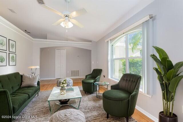 living room featuring light hardwood / wood-style flooring, ceiling fan, and lofted ceiling