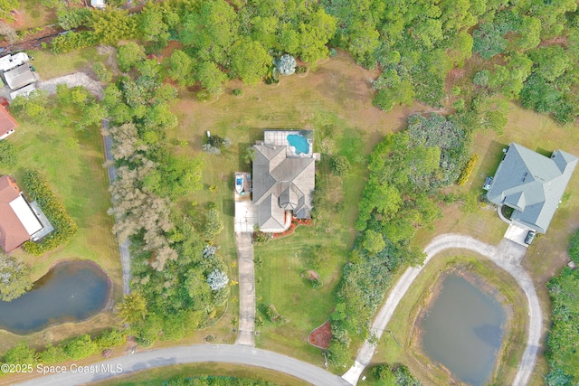 birds eye view of property with a water view