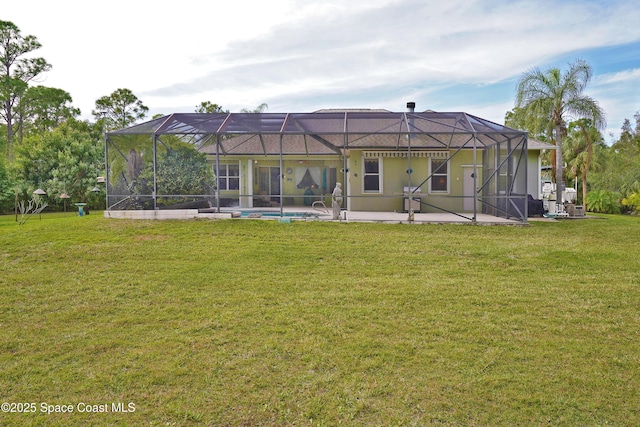 rear view of property with a lawn and a lanai