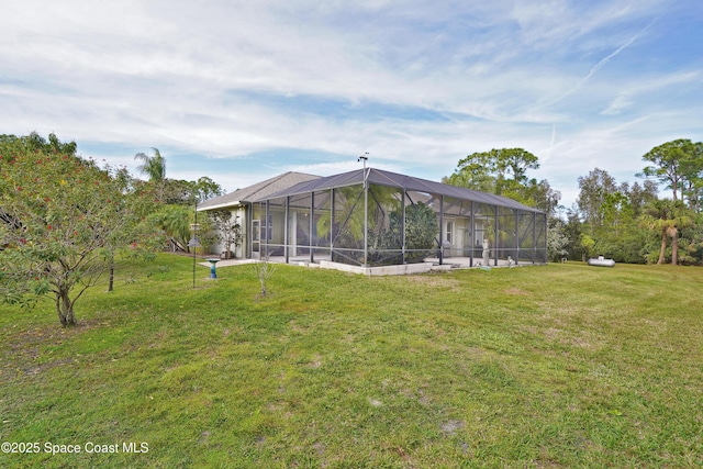 rear view of property featuring a lanai and a lawn