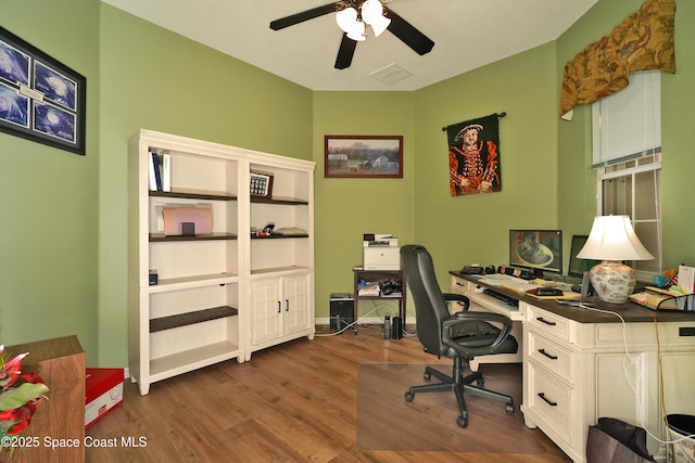 home office with ceiling fan and dark wood-type flooring