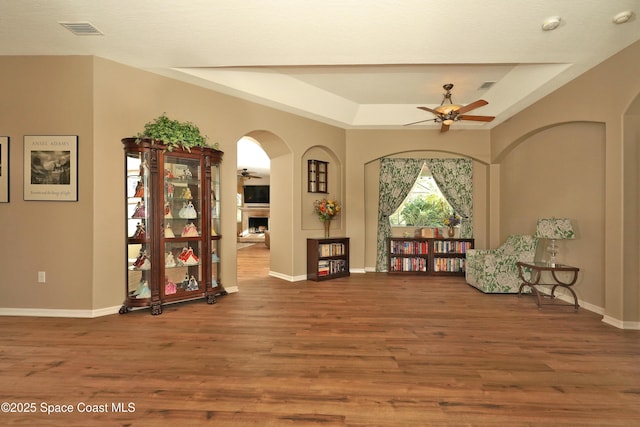 interior space featuring hardwood / wood-style floors and a raised ceiling