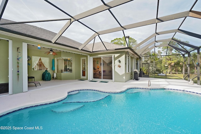 view of swimming pool with ceiling fan, a patio area, and a lanai