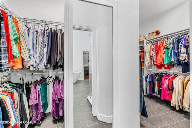 spacious closet with dark tile patterned flooring