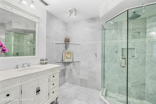 bathroom featuring vanity and a shower with shower door