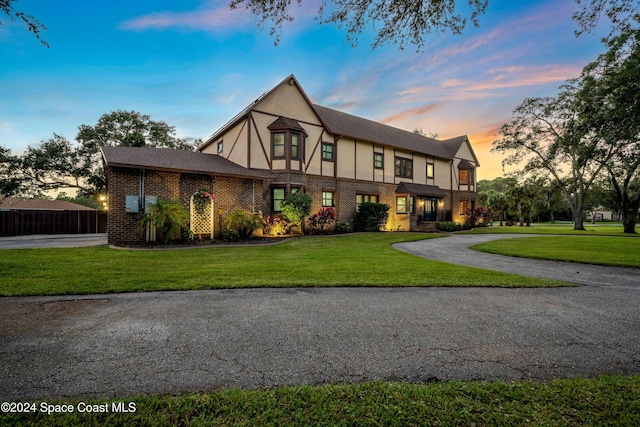 tudor home with a yard