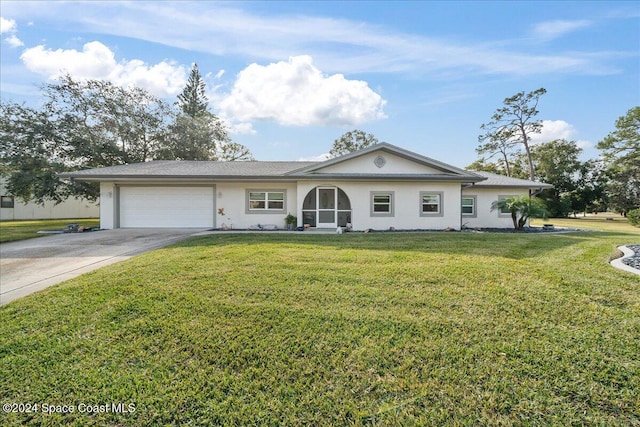 ranch-style house featuring a garage and a front yard