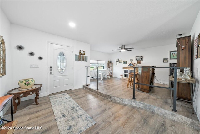 entrance foyer with ceiling fan and light hardwood / wood-style floors