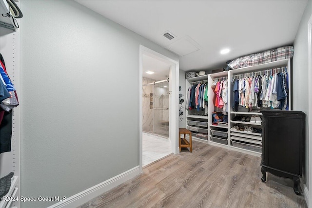 walk in closet with hardwood / wood-style floors